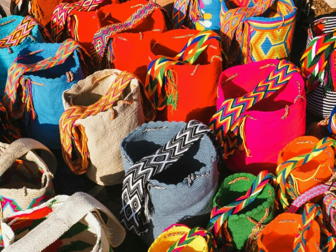 Colorful woven bags with patterned straps arranged together
